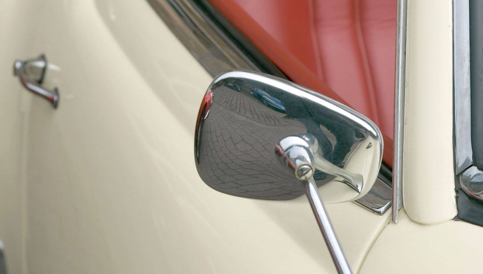 Close up frontal view of the passenger side of an antique or vintage car.